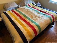 Blanket spread on queen bed showing overall size and stripe pattern