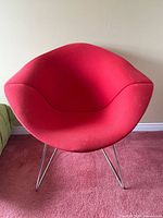 Front view of red Bertoia Diamond chair on chrome base