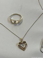 Ring and part of chain with pendant displayed