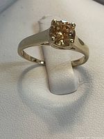 Top view of yellow gold ring with amber cubic zirconia