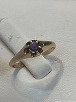 Front view of ring showing synthetic sapphire and floral bezel
