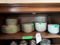 Stacks of dinner and salad plates, bowls visible