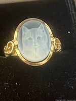 Front view of ring showing blue agate cat cameo and gold setting