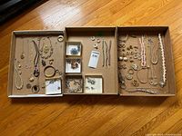 Wide view of three trays showing entire jewelry assortment