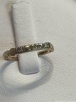 Ring front view showing three diamonds in band