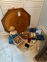 Overall lot view with crokinole board, doll, blocks, games