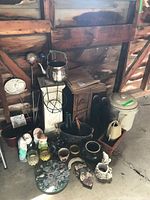 Overall lot showing crock, pedestal, planters, boots, watering cans and decor pieces