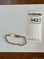 Full view of bracelet with ID plate and chain