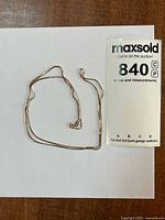 Full view of gold chain on white background with lot tag