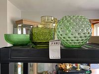 All four glass items on shelf