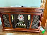 Front view of Innovative Technology ITVS-750B wooden music center showing controls and speakers