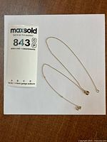 Entire necklace laid flat showing chain and pendant