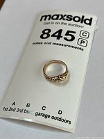 Ring on MaxSold tag showing overall appearance and stamp reference