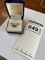 Ring in presentation box showing gold setting and stone