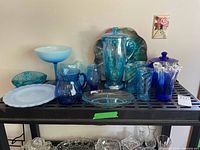 Group shot of all blue glass pieces on shelf