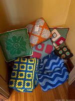 Group view of all pillows and blankets in corner