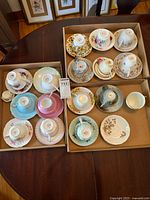 Overview of two boxes containing teacup and saucer sets
