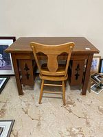 Front view of oak Mission style desk with pierced side panels