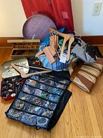 Group shot showing jewelry organizer, tins, trays, hangers and handbags