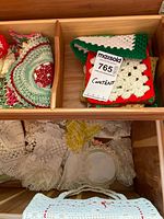 Chest interior showing assorted lace and crochet linens