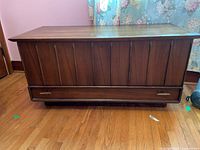 Front view of cedar blanket chest showing vertical panel design and lower drawer