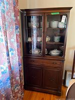Full view of mahogany china cabinet showing upper glass doors, drawers, lower cabinet