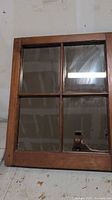 Front view of four-pane window mirror in wooden frame