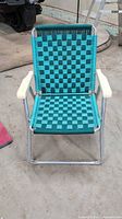 Front view of aluminum lawn chair showing full woven seat and back