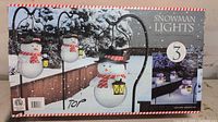 Front of box showing three snowman lights, product name, and set size