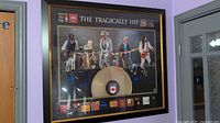 Full view of framed Tragically Hip picture on wall