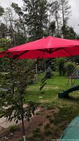 full view of open red canopy in garden setting