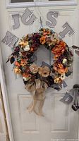 Full view of fall wreath on door showing overall design and size