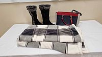 Overall lot showing blanket, boots, handbag