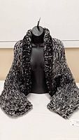 Front view of hand-knit shrug displayed on mannequin