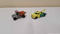Both toy trucks side by side on white background