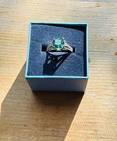Ring in presentation box, top view highlighting gemstone