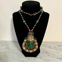 Full necklace on display bust showing chain, beads and pendant