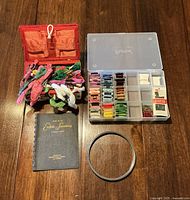 All items in lot: sewing basket with floss, organizer box with floss bobbins, smocking booklet, metal hoop