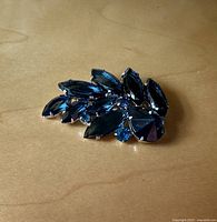 Front view showing deep sapphire navette stones and lighter blue rhinestones