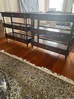 Pair of mahogany étagères side by side showing overall design and scale