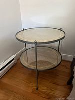 Full view of round two-tier rattan and wood side table