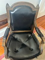 Front view of chair showing leather backrest and seat
