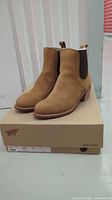 Front view of honey leather Chelsea boots on original box