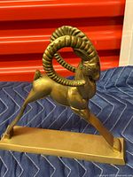 front angled view showing full ram sculpture and base