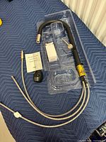 Entire faucet assembly with hoses, sprayer, mounting parts in plastic tray