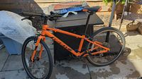 Full left side view of orange Giant bicycle