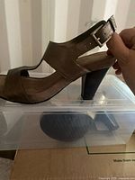 full side view of sandal showing upper, heel and buckle