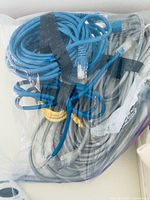 Bag containing multiple blue and grey Ethernet cables
