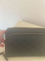 Front view showing quilted exterior and dual zippers