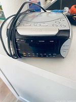 Front view showing digital display, buttons and attached cord